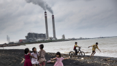 Children play by the beach near a coal power plant in Jepara, Central Java. 